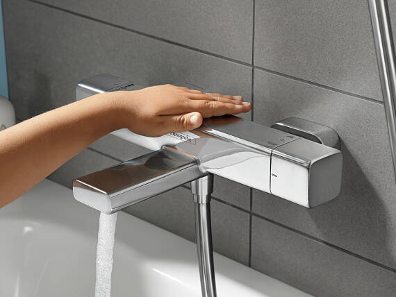 用手触摸易斯达 E 恒温龙头。