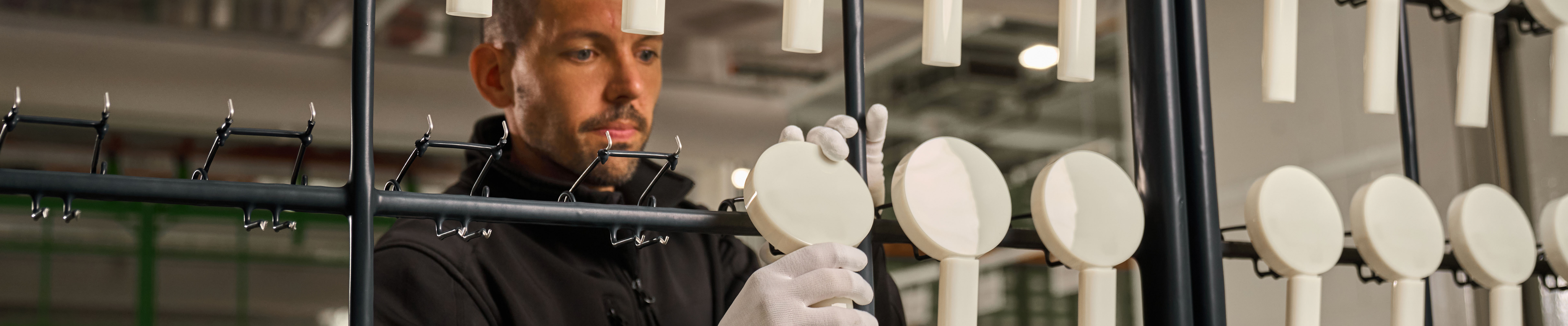 一位男士在汉斯格雅生产车间检查花洒。